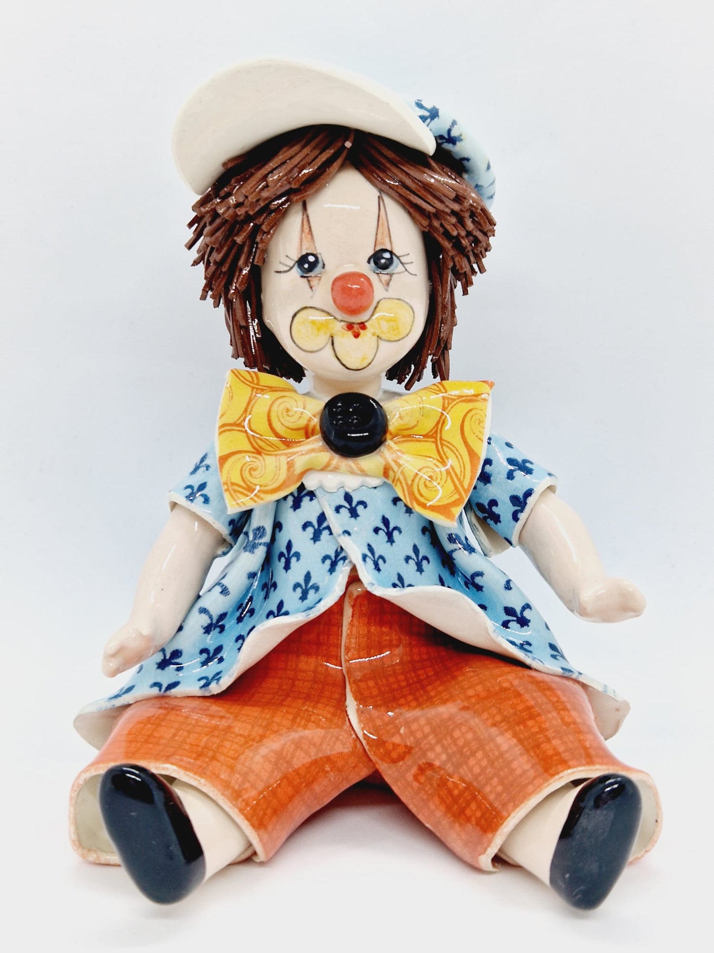 Sitting boy with cap