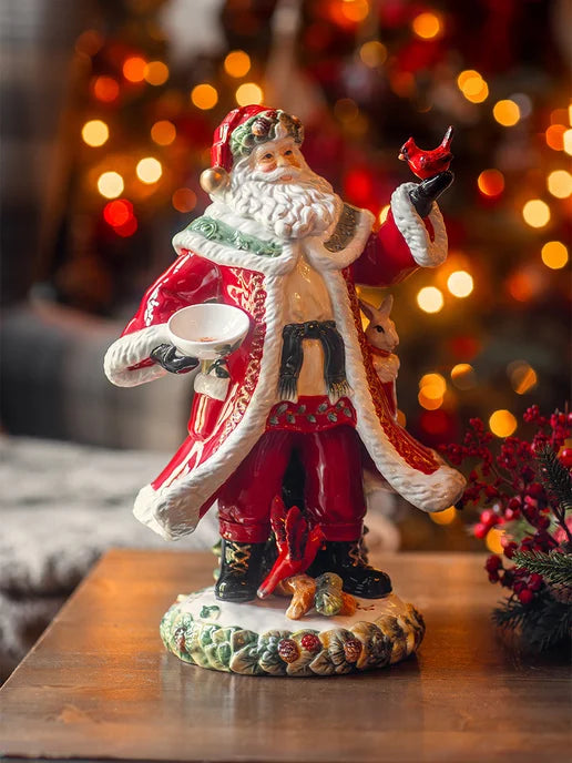 Porcelain Santa Clause holding a cardinal
