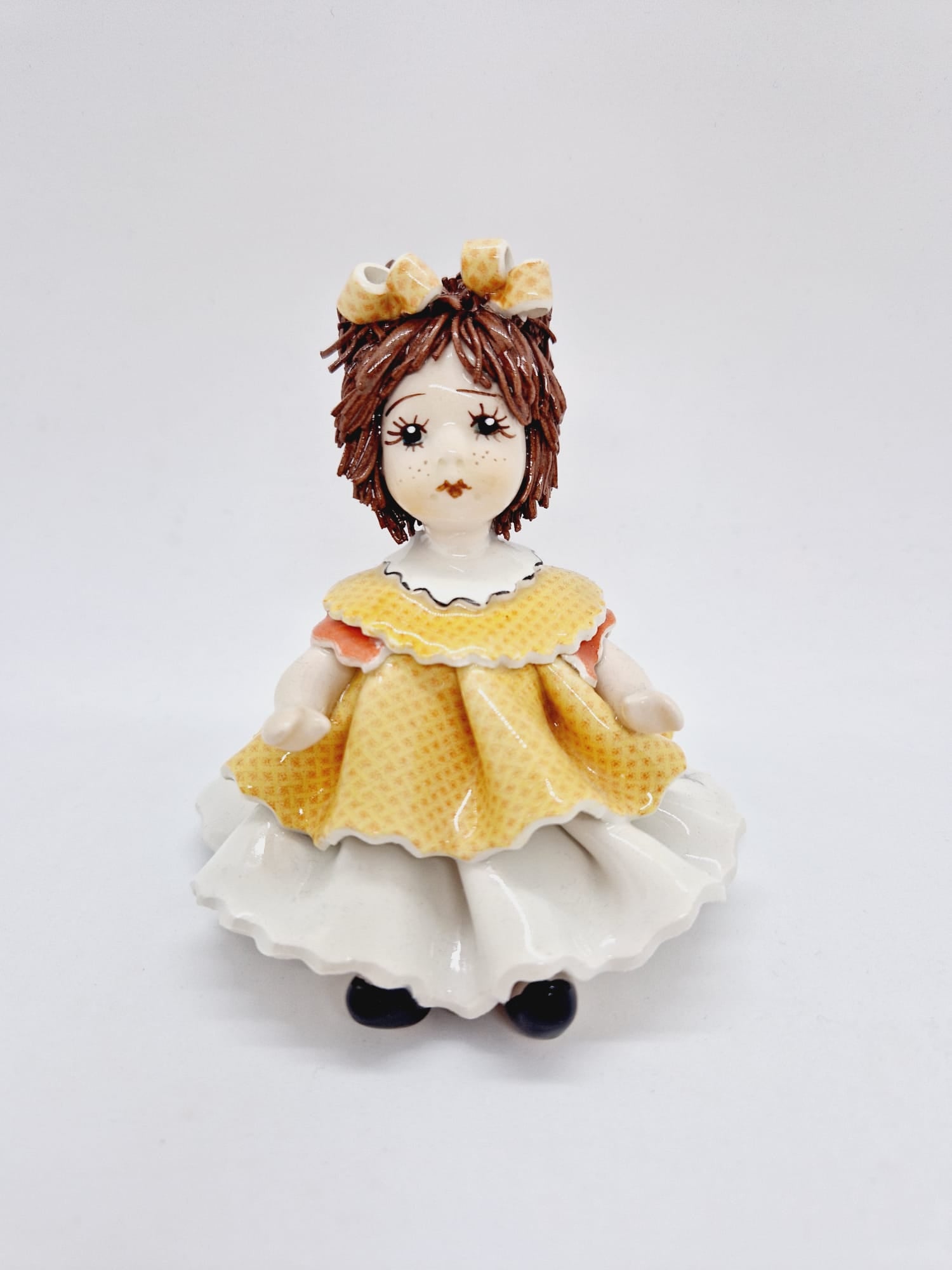 Sitting doll with orange dress