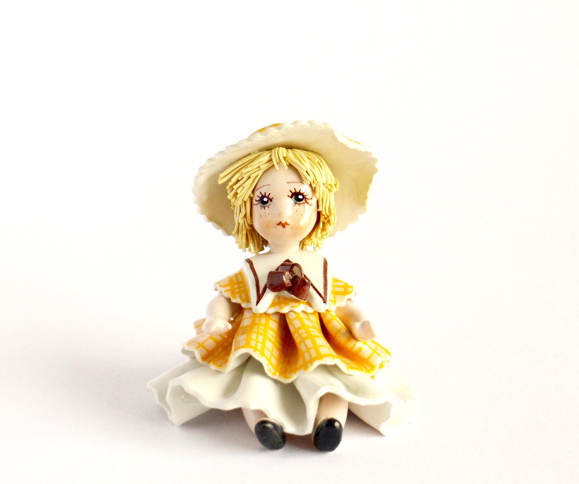 Sitting doll- yellow white dress