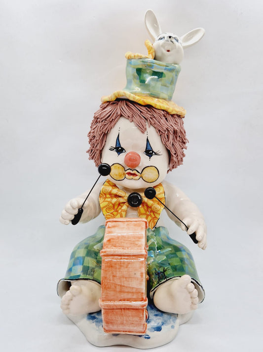 Sitting clown with a rabbit in a hat