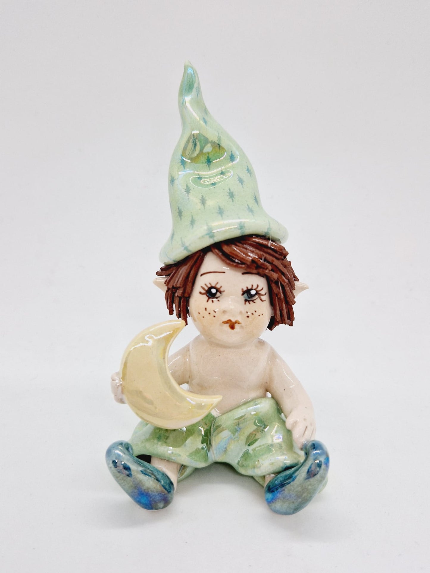 Sitting elf holding moon