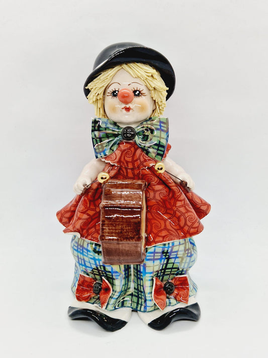 Clown musician on drum