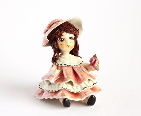 Sitting doll with flower