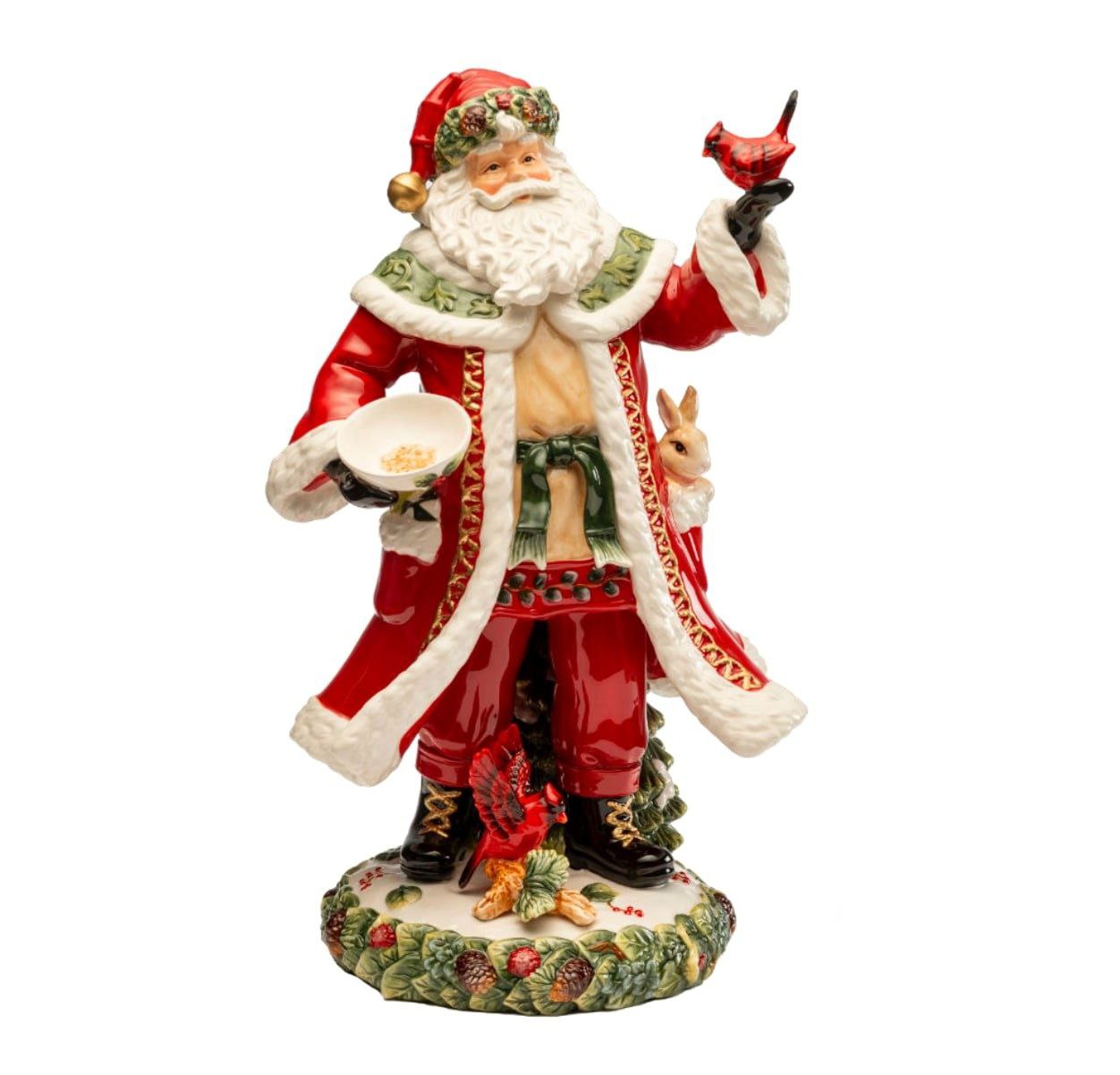 Porcelain Santa Clause holding a cardinal